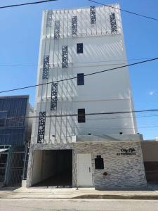 a tall white building with a door in front of it at Executive 1BR Downtown POS with ensuite bath in Port-of-Spain