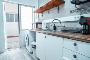 a kitchen with white cabinets and a sink at Blue Bay in Lagos