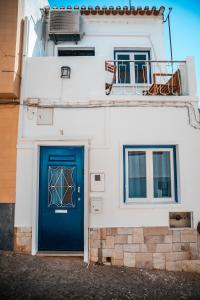 a blue door on the side of a white building at Blue Bay in Lagos