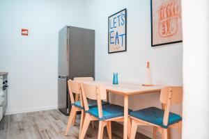 a kitchen with a table with chairs and a refrigerator at Blue Bay in Lagos