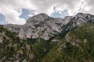 a view of a mountain range with clouds in the sky at Hotel Porto Tara in Žabljak +57 photos