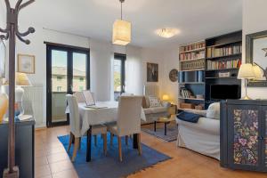 a living room with a dining room table and a couch at Appartamento Moser P in Levico Terme