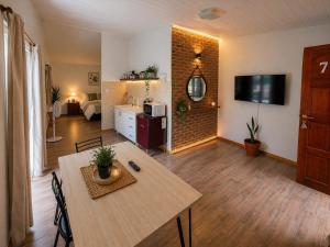 a living room with a table and a room with a bedroom at La Margarita Aparts - Solo 2 Pax in Mina Clavero