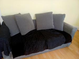 a bed with two pillows and a blanket at Entire flat with 2 separate rooms in Norwood