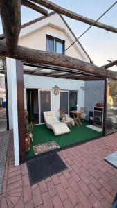 a covered patio with a couch and a table at Comfort Garden in Dunajská Streda