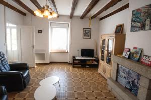 a living room with a couch and a fireplace at location Vakañsoù in Lanouée +5 photos
