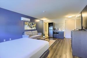 a hotel room with a bed and a kitchen at Sweet Stay in Hershey