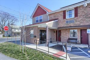 a brick house with a stop sign in front of it at Sweet Stay in Hershey