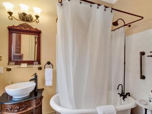 a bathroom with a white shower curtain and a sink at Proctor Mansion Inn in Wrentham +70 photos
