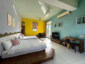 a bedroom with a bed and a desk in a room at Mei Shiou B&B in Dongshan