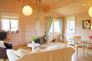 a living room with a couch and a table at Curlew Lodge in Dumfries