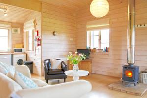 a living room with a couch and a wood stove at Curlew Lodge in Dumfries +15 photos
