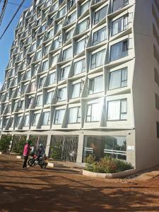 a building with a motorcycle parked in front of it at Hise Haven Stays in Kiambu