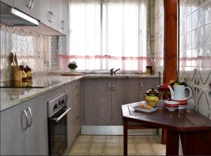 a kitchen with a table and a sink at Lo Racó del Delta in Sant Jaume d'Enveja