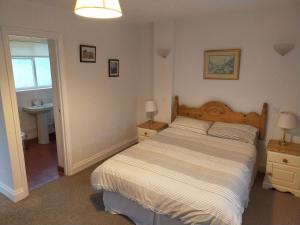 a bedroom with a large bed and a sink at The Green Dragon Inn in Redditch