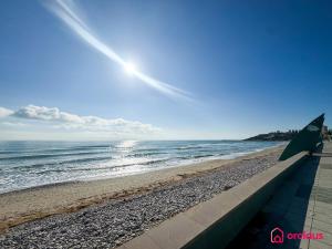 a view of the beach with a green umbrella at Poble Mar 7 in Oropesa del Mar