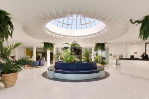 a lobby with a fountain in the middle of a building at H10 Suites Lanzarote Gardens in Costa Teguise +65 photos