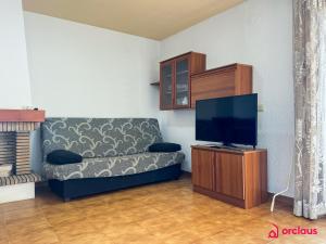 a living room with a couch and a flat screen tv at Poble Mar 7 in Oropesa del Mar