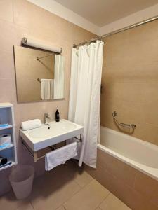 a bathroom with a white sink and a shower at Darkin 10 in Strožanac +16 photos