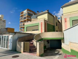 a brick building with a spiral staircase in front of it at Poble Mar 7 in Oropesa del Mar