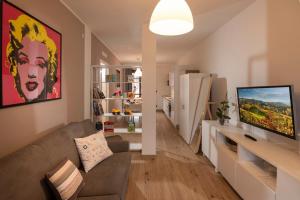 a living room with a couch and a flat screen tv at Casa Valentin in Monforte dʼAlba
