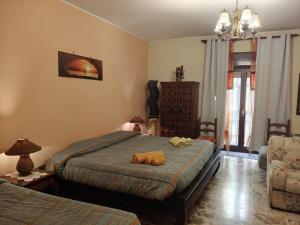 a bedroom with a bed with two towels on it at Bed and Breakfast Baobab in Piazza Armerina