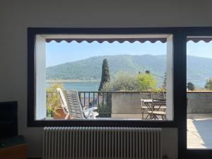 a window view of a patio with a table and chairs at Sarnico Terrazza sul lago di Iseo in Sarnico