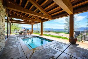 an outdoor patio with a pool and a table and chairs at Powder Mtn Trapper Lodge TR1 Ski Retreat Game Rm in Eden