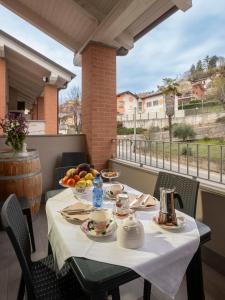 a table with plates of food on a balcony at Casa Valentin in Monforte dʼAlba