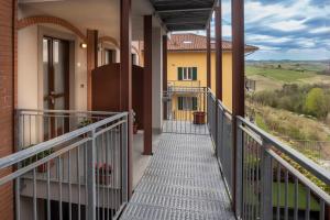 a walkway leading to a house with a balcony at Casa Valentin in Monforte dʼAlba