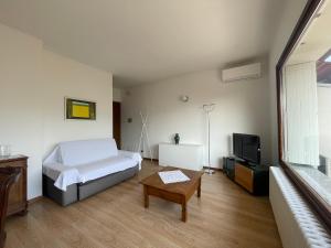 a bedroom with a bed and a table and a tv at Sarnico Terrazza sul lago di Iseo in Sarnico