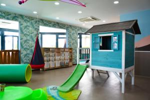 a play room with a slide and a play house at H10 Suites Lanzarote Gardens in Costa Teguise