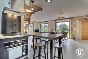 a kitchen with a large wooden table and chairs at La casa de silz in Arzal