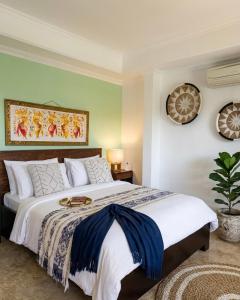a bedroom with a large bed in a room at Ellies Hotel in Nusa Dua +51 photos