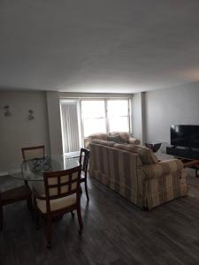 a living room with a couch and a glass table at Convenient Downtown Apartment in Saint Louis +5 photos