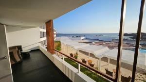 a view of the ocean from the balcony of a hotel at Le Grand Hotel Ilo in Ilo