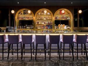 a row of chairs sitting in front of a bar at Grand Mercure Imperial Palace Seoul Gangnam in Seoul