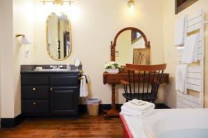 a bathroom with a sink and a mirror at Stonecroft Inn in Ledyard Center +15 photos