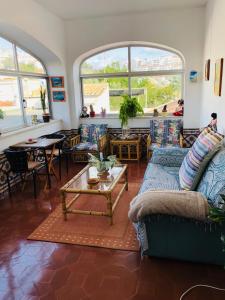a living room with a couch and a table at Maria Guest house in Albufeira