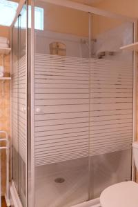 a shower with a glass door in a bathroom at Charming apartment in Porto-Vecchio in Porto-Vecchio