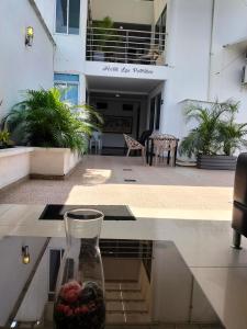 a glass vase sitting on a table in front of a building at Hotel Los Potrillos in Aguazul +5 photos