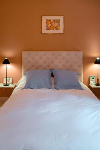 a bedroom with a large white bed with two pillows at Charming apartment in Porto-Vecchio in Porto-Vecchio