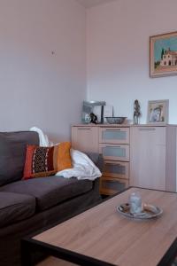 a living room with a couch and a table at Charming apartment in Porto-Vecchio in Porto-Vecchio +9 photos