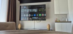 a living room with a tv on a wall at Apartman Ivan Trebinje in Trebinje