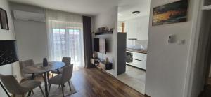 a kitchen and dining room with a table and chairs at Apartman Ivan Trebinje in Trebinje