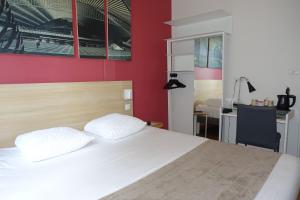 a bedroom with a white bed and a red wall at Hôtel de la Gare - Restaurant Bistro Quai in La Roche-sur-Yon