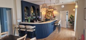 a bar in a restaurant with stools at The Osborne in Shanklin