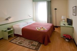 Postel nebo postele na pokoji v ubytování Hotel Valbrenta