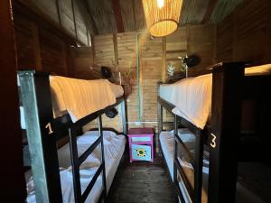a room with two bunk beds and a lamp at Casa en el agua in Tintipan Island