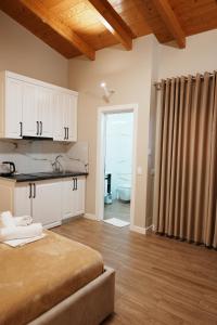 a room with a bed and a kitchen with a window at Arial Penthouse Suites in Vlorë +248 photos